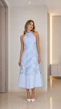 Model wearing light blue halter neck floral lace midi dress front view
