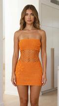 Front view of model wearing orange strapless crochet mini dress