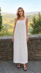 Front view of woman wearing white eyelet maxi dress