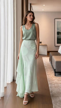 Model wearing sage green satin top and polka dot maxi skirt front view