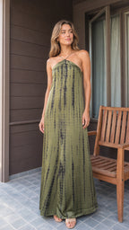 Front view of woman wearing olive tie-dye halter maxi dress