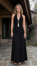 Front view of black halter neck maxi dress on model