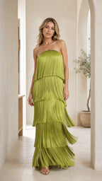 Front view of woman wearing olive green strapless tiered fringe maxi dress