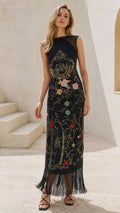 Front view of model wearing black embroidered fringe maxi dress