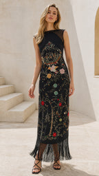 Front view of model wearing black embroidered fringe maxi dress