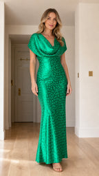 Front view of woman wearing green draped cowl neck maxi dress