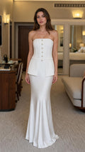 Front view of woman wearing white strapless corset peplum mermaid dress