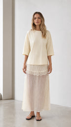 Front view of woman wearing cream relaxed tee and matching mesh maxi skirt