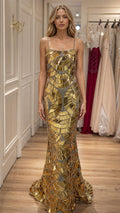 Front view of model wearing gold sequin mermaid evening gown