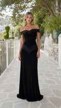 Model wearing black off-the-shoulder evening maxi dress from the front