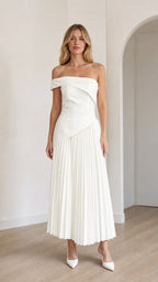 Model wearing white off-shoulder asymmetric pleated midi dress from front