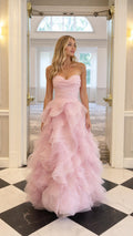 Front view of model wearing pink strapless tulle ball gown evening dress