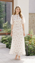 Front view of woman wearing off-white floral maxi dress