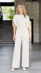 Front view of woman wearing ivory round neck split sleeve pants set