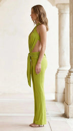 Side profile view of lime green jumpsuit showing flare leg
