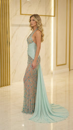 Side profile of mint formal gown with flowing train