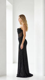 Side view of black sequin evening dress with slit