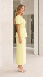 Side profile view of yellow skirt set
