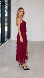 Side profile view of burgundy lace maxi dress showing slit