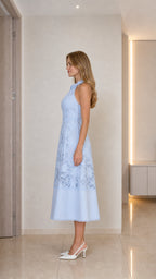 Model wearing light blue lace midi dress side view