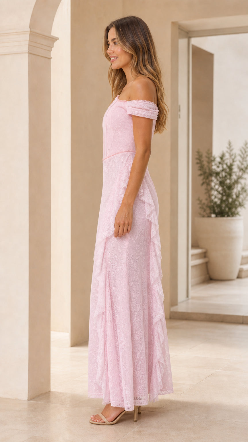 Side profile view of pink lace maxi dress