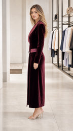 Side profile view of burgundy velvet blazer dress