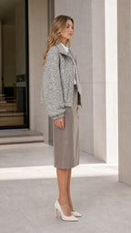 Side profile view of woman in grey tweed jacket