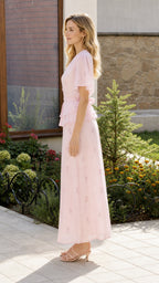 Side profile view of pink two-piece maxi set