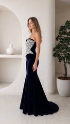 Side profile view of navy velvet gown