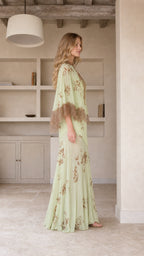Model wearing mint green floral maxi dress, side profile