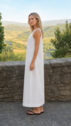 Side profile of woman in white eyelet maxi dress