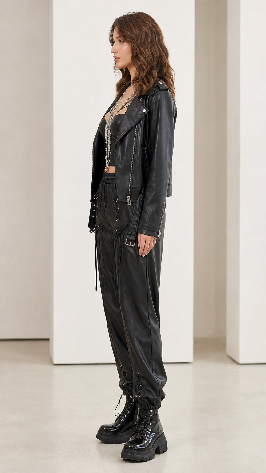 Model wearing black faux leather set from the side profile