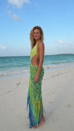 Side profile view of green blue sequined fringe maxi dress
