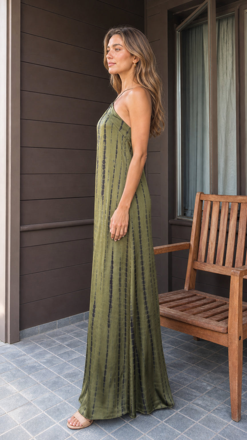 Side profile view of woman in olive tie-dye maxi dress