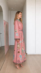 Model wearing pink boho printed long sleeve maxi dress, side profile