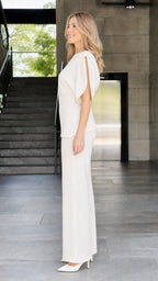 Side view of woman wearing ivory two-piece set