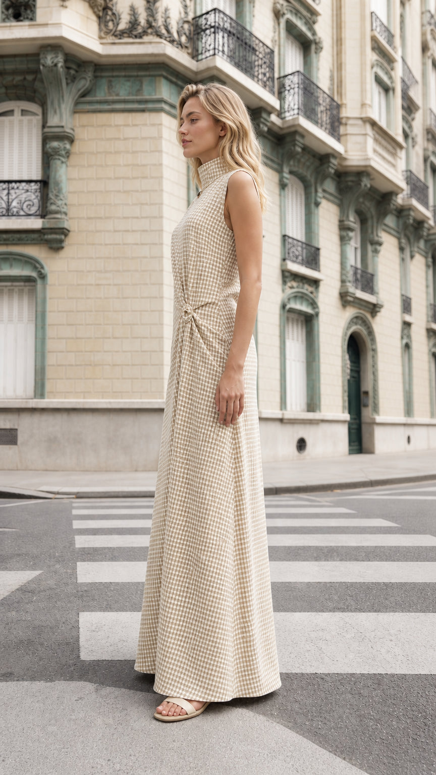 Side profile of model wearing beige gingham maxi dress