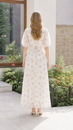 Back view of woman in off-white floral maxi dress