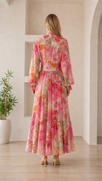 Back view of woman wearing pink floral maxi dress