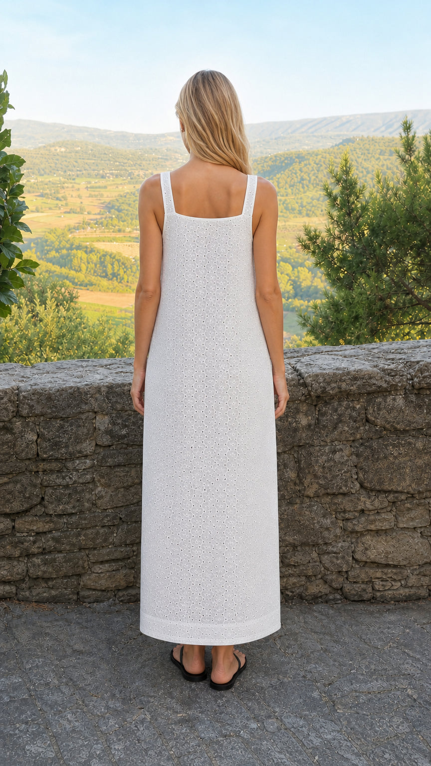 Back view of woman in white eyelet maxi dress