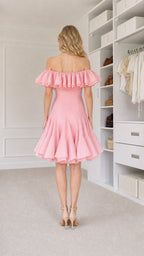 Back view of model in pink mini dress