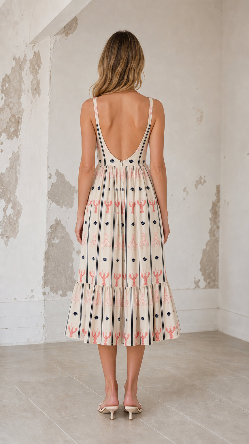 Back view showcasing scoop back detail on cream midi dress