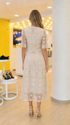 Back view of model wearing Beige lace top and midi skirt