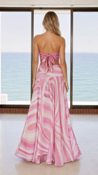 Back view of woman showing adjustable tie-back detail on pink scarf top
