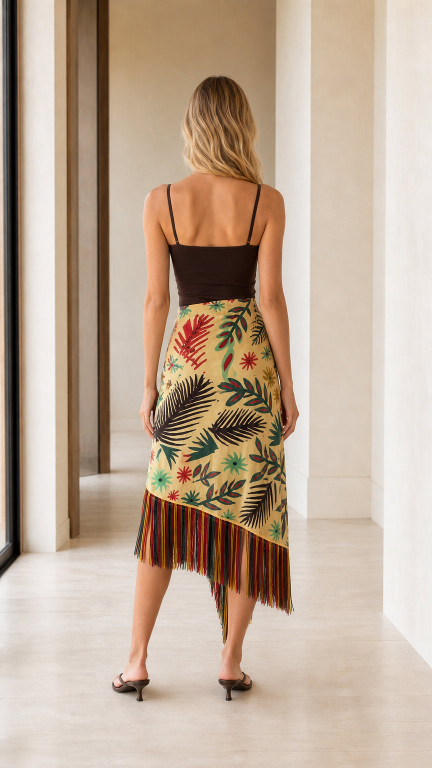 Model wearing yellow wrap skirt back view