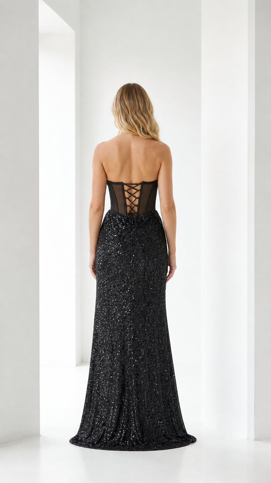 Back view of black evening gown showing lace-up corset detail