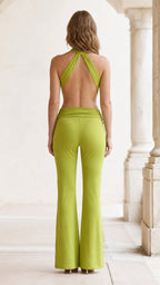 Back view of lime green jumpsuit featuring open back design