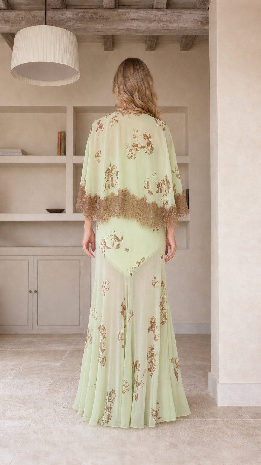 Model wearing mint green floral maxi dress, back view