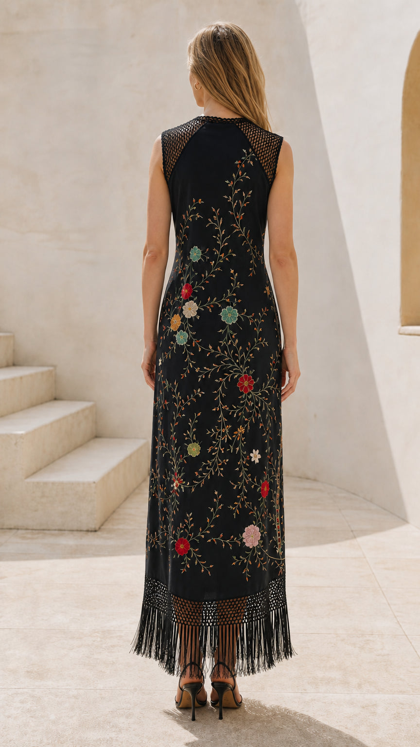Back view of model wearing black embroidered fringe maxi dress