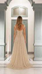 Back view showing sweep train of champagne gown